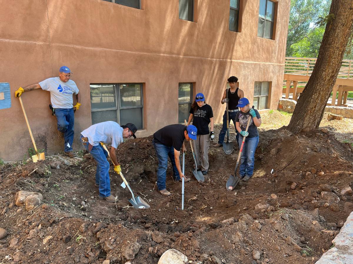 The River Source crew creates the swale and loosens the soil for the Rain Garden. 